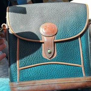 Dooney and Bourke leather black purse with brown leather trim.